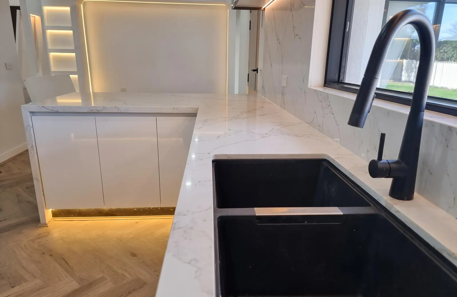 Stone benchtop with undermount black sink