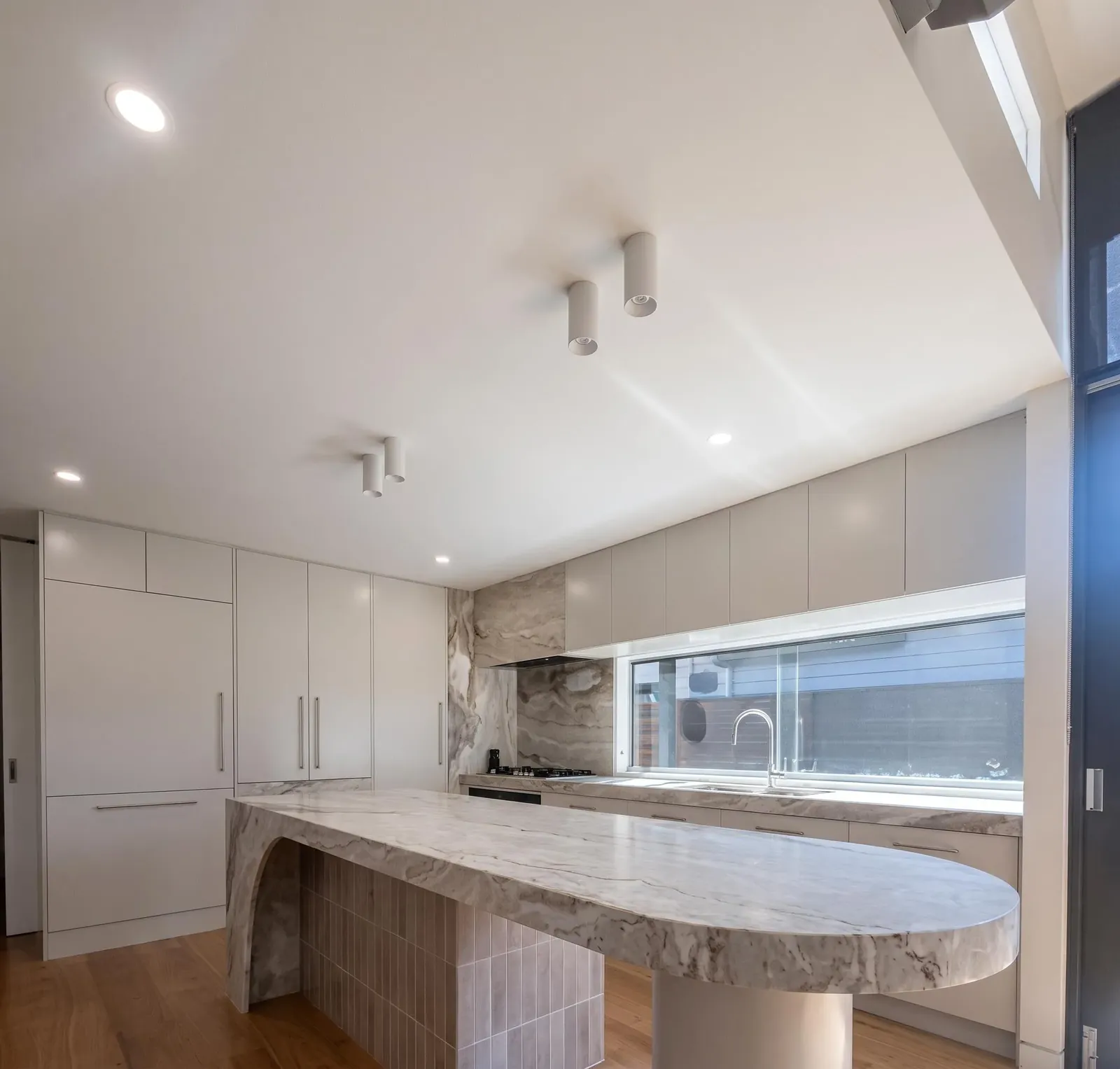 Curved sculptural stone island by Melbourne Marble Designs