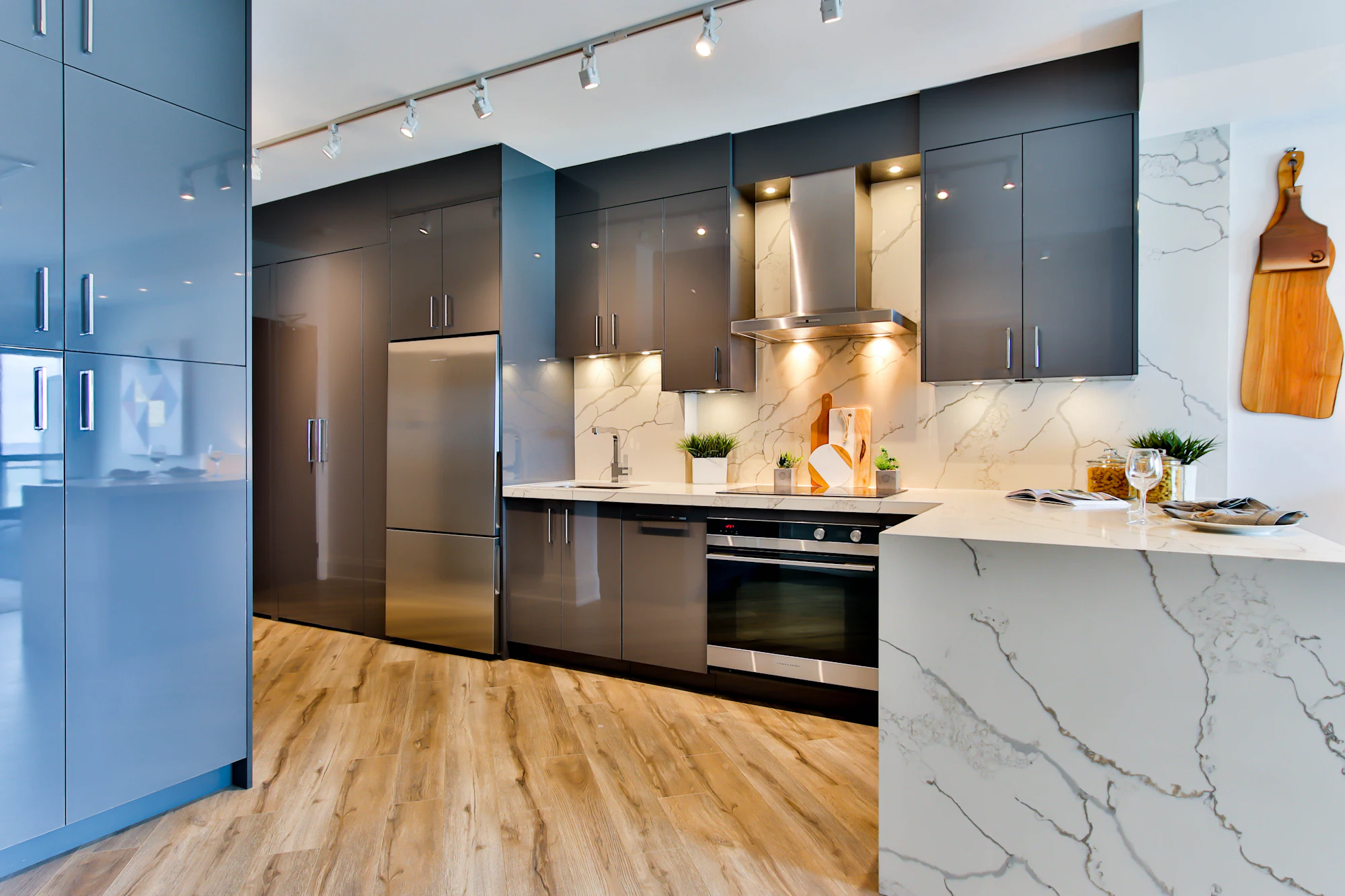 Marble waterfall island benchtop in a modern dark kitchen